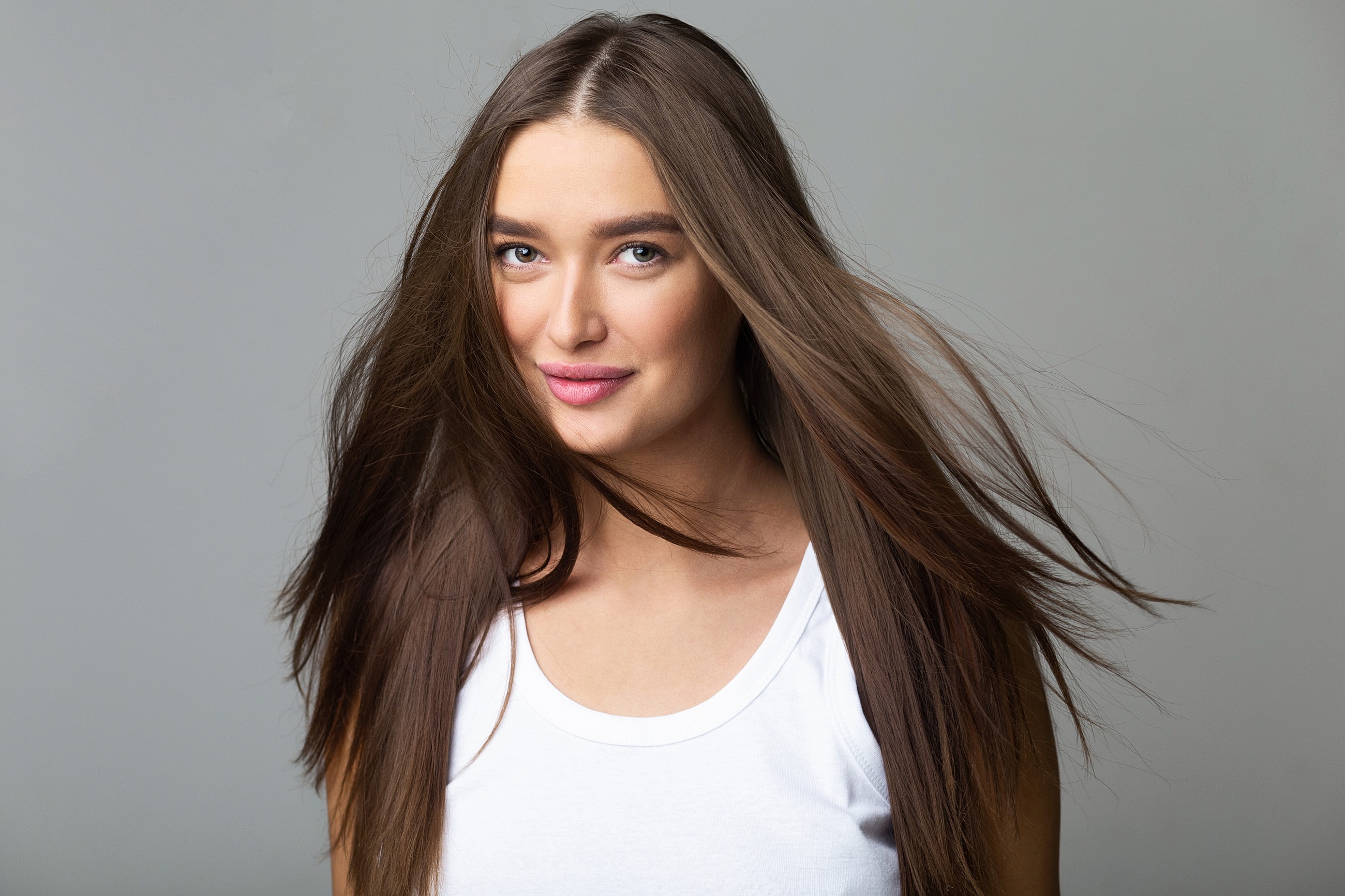 Woman with flowing hair and smiling expression.